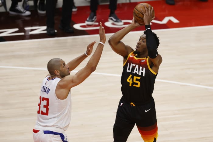 Donovan Mitchell (45) scores over Nicolas Batum (33)